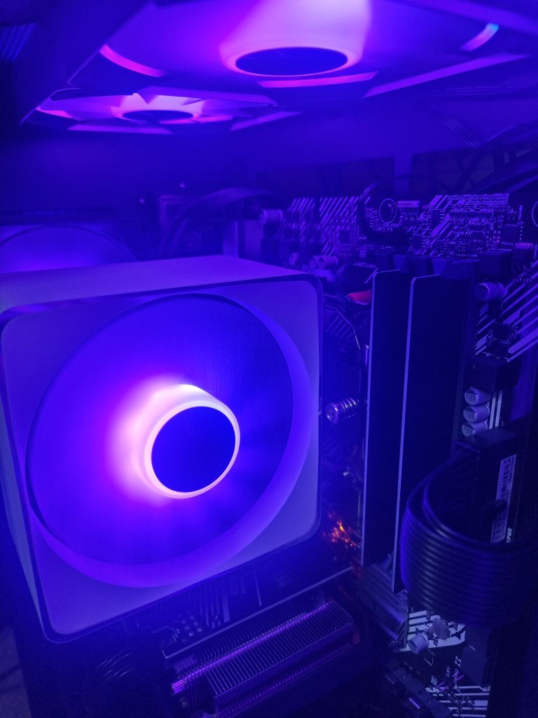 photo showing the inside of the pc case with the cpu cooler being the main focus of attention. It is lit in a Cadbury purple.